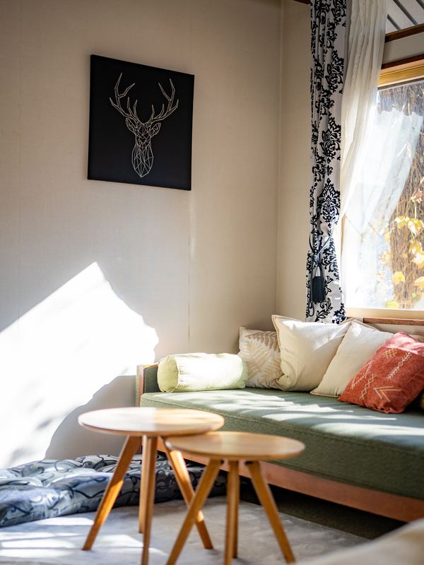 A daybed in the Deluxe room in the afternoon sun