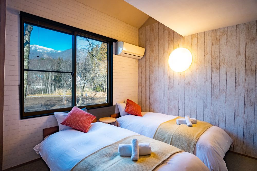 The Standard room, twin beds and a window onto the mountains