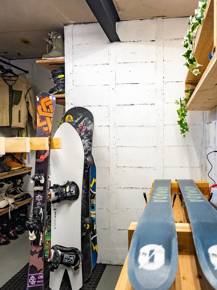 The ski room, boards and boots racked along the walls